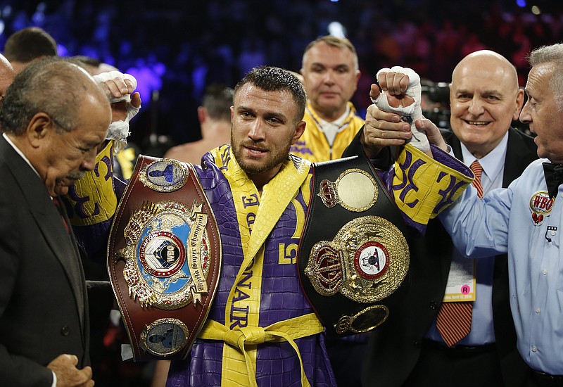 Vasiliy Lomachenko celebrates defending his WBA/WBO lightweight titles on April 12, 2019, after knocking out Anthony Crolla, in Los Angeles. Teofimo Lopez defeated Lomachenko Saturday in Las Vegas to unify the lightweight titles. - Photo by Damian Dovarganes of The Associated Press story.lead_photo.caption