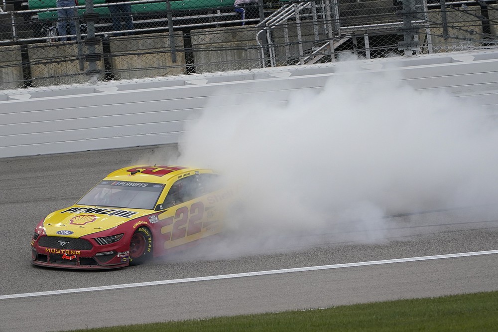 Joey Logano celebrates after winning a NASCAR Cup Series auto race at Kansas Speedway in Kansas City, Kan., Sunday, Oct. 18, 2020. (AP Photo/Orlin Wagner)