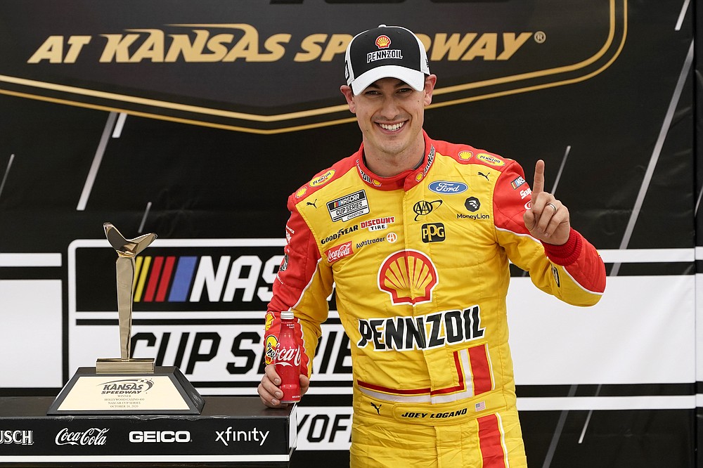 Joey Logano celebrates in victory lane after winning a NASCAR Cup Series auto race at Kansas Speedway in Kansas City, Kan., Sunday, Oct. 18, 2020. (AP Photo/Orlin Wagner)