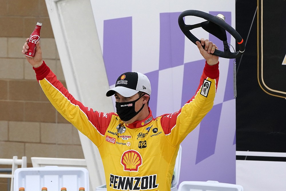 Joey Logano celebrates in Victory Lane after winning a NASCAR Cup Series auto race at Kansas Speedway in Kansas City, Kan., Sunday, Oct. 18, 2020. (AP Photo/Orlin Wagner)