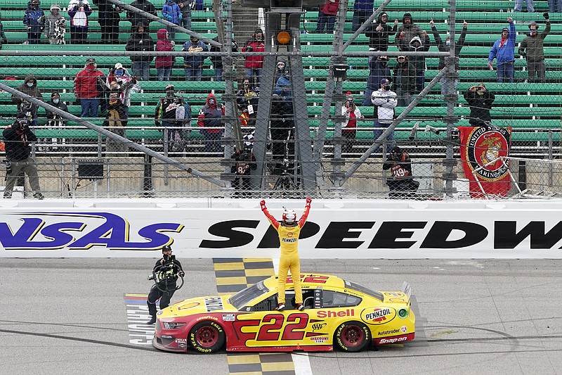 Joey Logano celebrates after winning a NASCAR Cup Series auto race at Kansas Speedway in Kansas City, Kan., Sunday, Oct. 18, 2020. (AP Photo/Orlin Wagner)