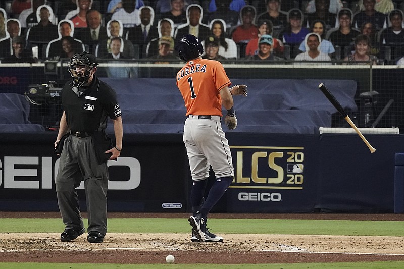 Houston Astros Carlos Correa tosses his bat and has words with home plate umpire Lance Barksdale after striking out during the fourth inning in Game 7 of a baseball American League Championship Series, Saturday, Oct. 17, 2020, in San Diego. (AP Photo/Jae C. Hong)