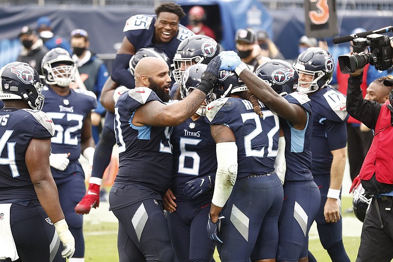 Tennessee Titans running back Derrick Henry (22) is mobbed by teammates after Henry scored the winning touchdown against the Houston Texans in overtime of an NFL football game Sunday, Oct. 18, 2020, in Nashville, Tenn. The Titans won 42-36. (AP Photo/Wade Payne)