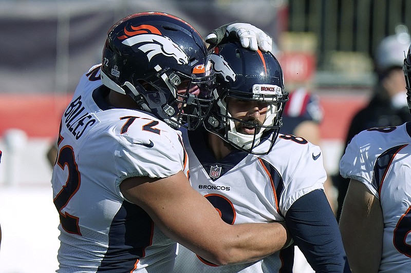 Denver Broncos offensive tackle Garett Bolles, left, congratulates kicker Brandon McManus in the second half of an NFL football game after his sixth field goal against the New England Patriots, Sunday, Oct. 18, 2020, in Foxborough, Mass. (AP Photo/Steven Senne)