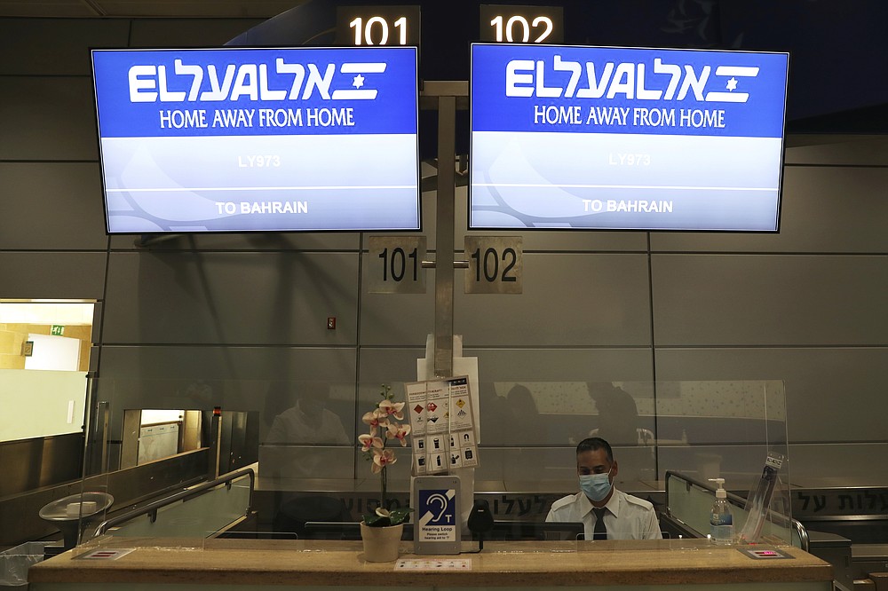Signs at the counter of Israeli flag carrier El Al shows flight details to Bahrain as Israel is due to send delegates to Bahrain to formalize relations and broaden Gulf cooperation, at Ben Gurion airport in Lod, near Tel Aviv, Israel Sunday, Oct. 18, 2020. (Ronen Zvulun/Pool Photo via AP)