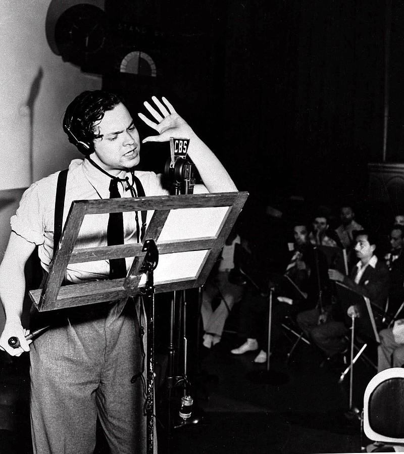 ADVANCE FOR SUNDAY, AUG. 22--FILE--Orson Welles reads from his script during the 1938 broadcast his radio show "The War of the Worlds." Wells' fictional account of a Martian invasion of Earth created widespread panic in the minds of thousands of listeners.   (AP Photo/File)
