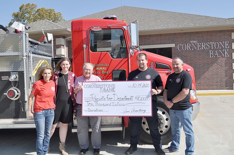 RACHEL DICKERSON/MCDONALD COUNTY PRESS Cornerstone Bank in Pineville recently donated $10,000 to the Pineville Fire Department. Pictured are, left, firefighters Chastity Derrisseaux and Kalee Sweeten, Jim Armstrong of Cornerstone Bank, Fire Chief Ryan Drake and firefighter Robert Drake.