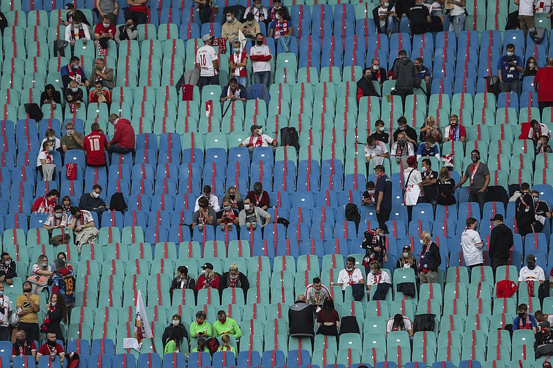 Soccer supporters keep social distance guidelines prior the German Bundesliga soccer match between RB Leipzig and FC Schalke 04 in Leipzig, Germany, Saturday, Oct. 3, 2020. (AP Photo/Michael Sohn)