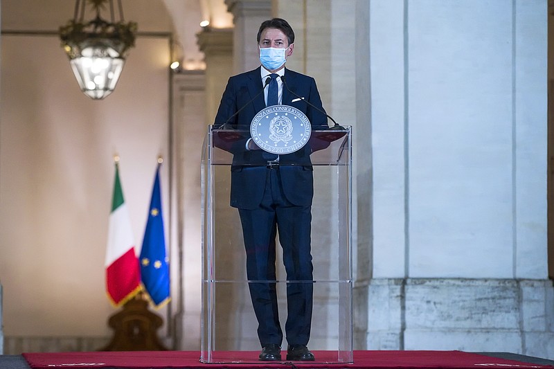 Italian Premier Giuseppe Conte meets the media in Rome, Sunday, Oct. 18, 2020. Conte on Sunday announced new measures aimed at halting the spread of coronavirus as infections continue to hit new daily highs, moving into the vulnerable population and putting fresh pressure on hospitals.  The restrictions stop short of a curfew like one imposed in Paris and other major French cities. But Italian mayors can close public squares and other gathering places after 9 p.m., permitting access only to reach homes or businesses. (Angelo Carconi/Pool Photo via AP)