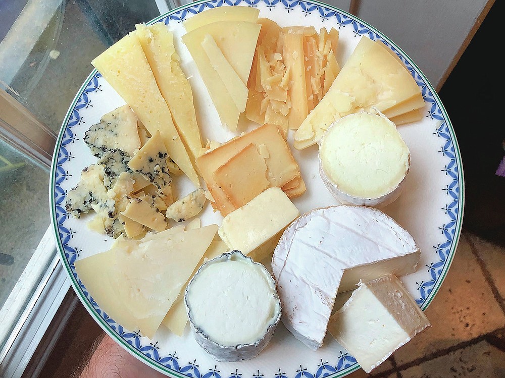 An array cheeses from Goot Essa, an Amish farmstead cheesemaker in Central Pennsylvania, include, clockwise: Der Edel Bleu Kase (far left); Der Alpen Kase, a cow's milk Alpine-style cheese; Der Mutterschaf Kase, a semi-soft sheep's milk Pecorino-style; Butta Schaf Kase, hard sheep's milk Pecorino-style, Felsa Yeh, a firm sheep's milk Manchego-style; Emanuel Vom Tal Kase, a bloomy rind sheep cheese; Der Weichen Gehl, a cow's milk Camembert; Marn Vom Berge Kase, an ash-ripened goat cheese. (Craig LaBan/The Philadelphia Inquirer via AP)