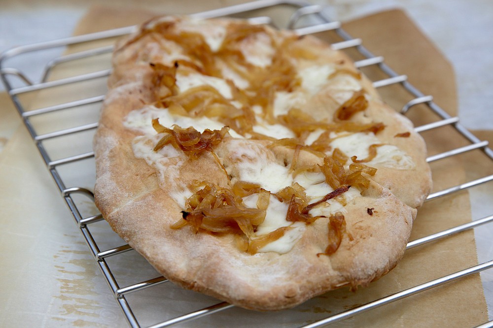 Homemade flatbreads with creative toppings, like this Caramelized Onions and Fontina Flatbread. (TNS/St. Louis Post-Dispatch/Hillary Levin)