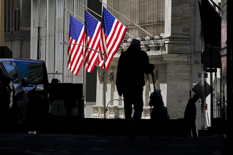 FILE - In this Oct. 14, 2020 file photo, pedestrians pass the New York Stock Exchange in New York. Stocks are opening higher on Wall Street Tuesday, Oct. 20 as traders look over several solid earnings reports from U.S. companies. (AP Photo/Frank Franklin II, File)