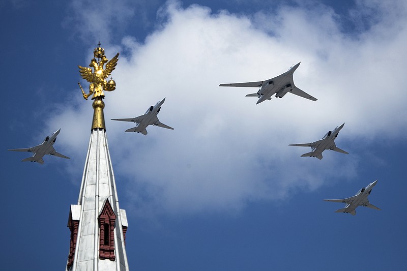 Russia's Air Force strategic bombers, Tu-160, center, and Tu-22M3, all others, fly over Red Square during the Victory Day military parade marking the 75th anniversary of the Nazi defeat in WWII, in Moscow, Russia, Wednesday, June 24, 2020. The Victory Day parade normally is held on May 9, the nation's most important secular holiday, but this year it was postponed due to the coronavirus pandemic. (AP Photo/Pavel Golovkin, Pool)
