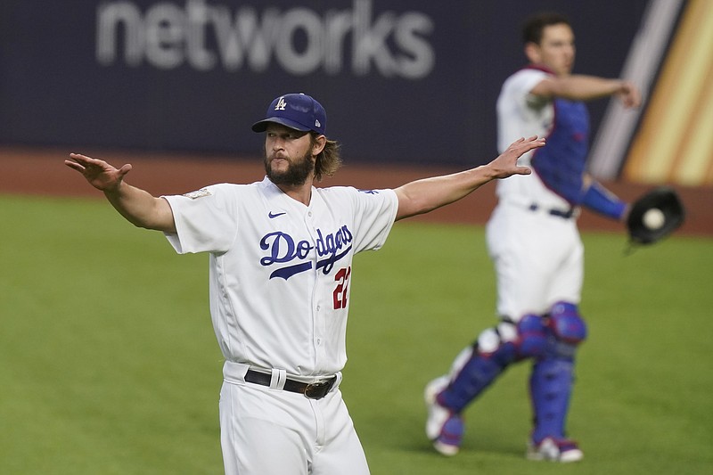 Los Angeles Dodgers starting pitcher Clayton Kershaw warms up before Game 1 of the baseball World Series against the Tampa Bay Rays Tuesday, Oct. 20, 2020, in Arlington, Texas. (AP Photo/Eric Gay)