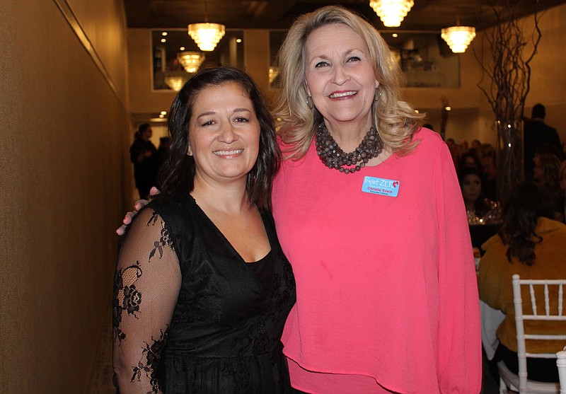 NWA Democrat-Gazette/CARIN SCHOPPMEYER Christie Erwin, Project Zero founder (right), and Tiphanie Gurwell, Northwest Arkansas outreach coordinator,  welcome guests to the inaugural Aiming for Zero NWA on Nov. 1.