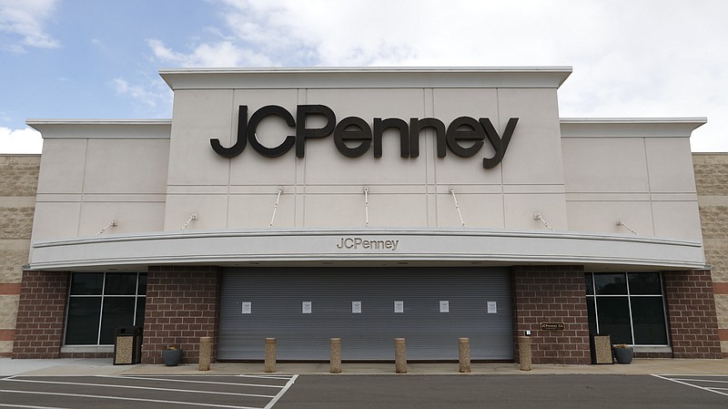 FILE - In this May 8, 2020 file photo, a parking lot at a JC Penney store is empty in Roseville, Mich.  J.C. Penney anticipates being out of bankruptcy protection before the December holiday season. The retailer said Wednesday, Oct. 21 that it filed a draft asset purchase agreement under which mall owners Brookfield Asset Management Inc. and Simon Property Group will acquire substantially all of its retail and operating assets through a combination of cash and new term loan debt. (AP Photo/Paul Sancya, File)
