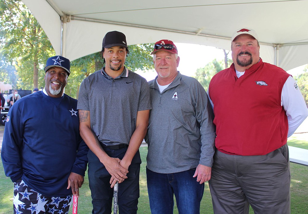 Joe Washington (from left), Wallace Spearmon, David Lipsmeyer and Scott Smith visit at the Pagnozzi Parker charity golf tournament. 
(NWA Democrat-Gazette/Carin Schoppmeyer)