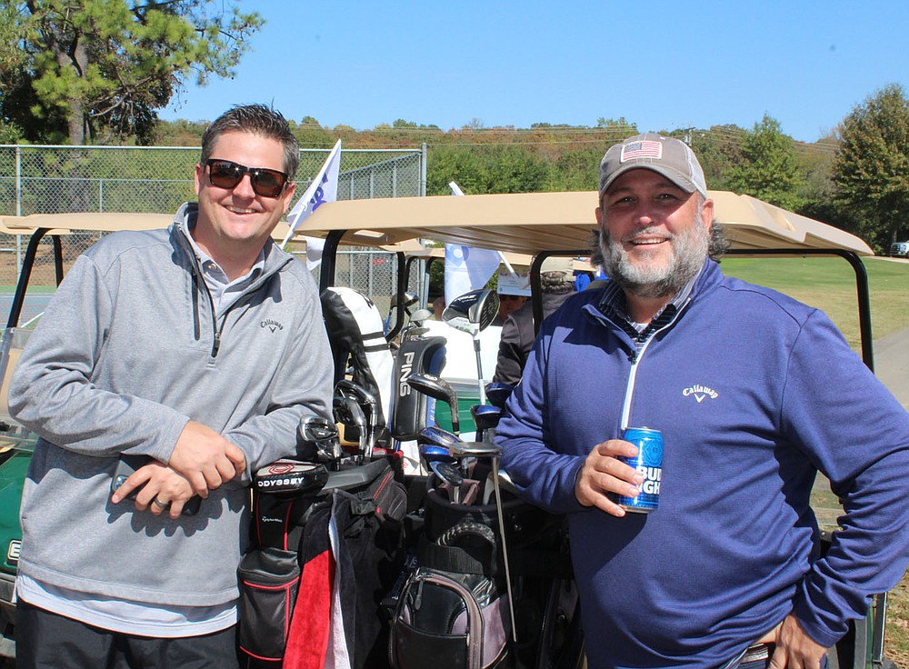 Jeff Herrington (left) and Trey Seavey play in the charity golf tournament Oct. 16.
(NWA Democrat-Gazette/Carin Schoppmeyer)