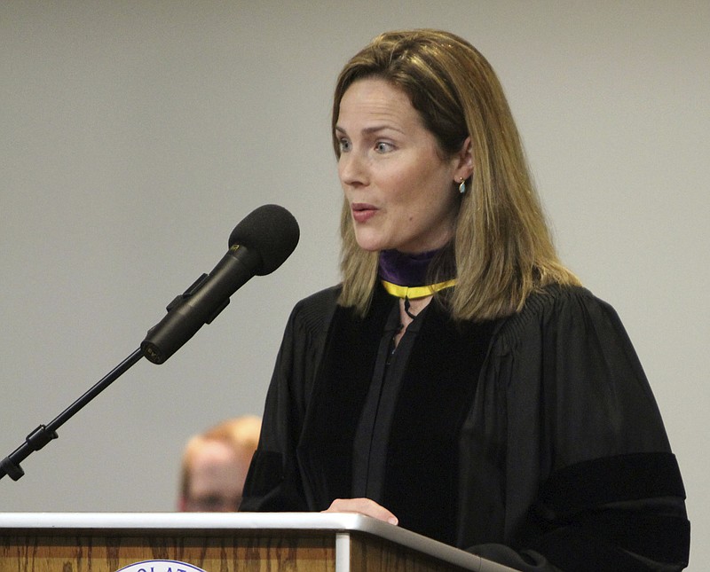 In this June 11, 2011, photo, then-University of Notre Dame law professor Amy Coney Barrett gives the commencement address to Trinity at Greenlawn graduates at the Trinity People of Praise Center in South Bend, Ind. Barrett served for nearly three years on the board of the private Christian schools that effectively barred admission to children of same-sex parents and made it plain openly gay and lesbian teachers weren’t welcome in the classroom. (Barbara Allison/South Bend Tribune via AP)