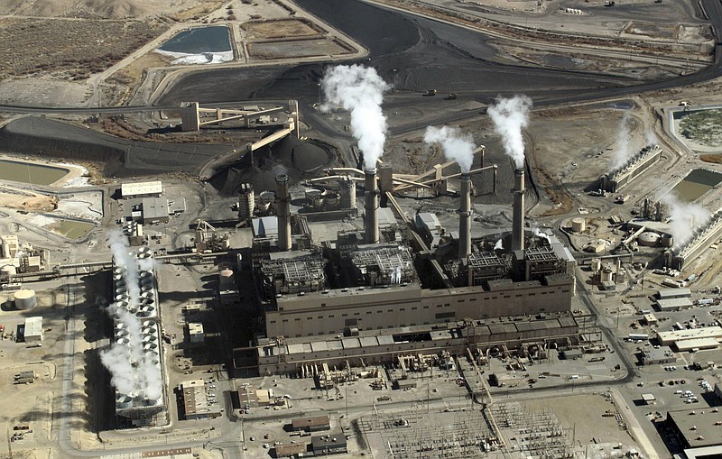 FILE - This Nov. 9, 2009, file photo shows the coal-fired San Juan Generating Station near Farmington, N.M. The parent company of New Mexico’s largest electric utility will become part of energy giant Iberdrola’s global holdings under a multibillion-dollar merger. Under the agreement announced Wednesday, Oct. 21, 2020, Iberdrola's majority-owned U.S. subsidiary Avangrid will acquire PNM Resources and its assets in New Mexico and Texas. The merger will require approval from a number of state and federal regulators in a process that's expected to take the next 12 months. (AP Photo/Susan Montoya Bryan, File)