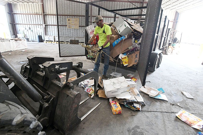 Mark Thomas of Lincoln unloads a trailer of cardboard Wednesday Oct. 21, 2020 at the Boston Mountain transfer station/recycling center in Prairie Grove. The Sustainability Consortium of the Northwest Arkansas Council released a report Wednesday saying the region has invested well in recycling, but more needs to be done to increase volume, coordinate the flow and create local markets for recycled material. Visit nwaonline.com/201019Daily/ for more images. (NWA Democrat-Gazette/J.T.WAMPLER)