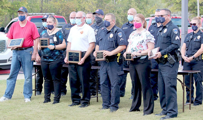 Keith Bryant/The Weekly Vista
Police and fire department personnel stand together after receiving recognition from the Bella Vista Baptist Church, including awards for years of service milestones.