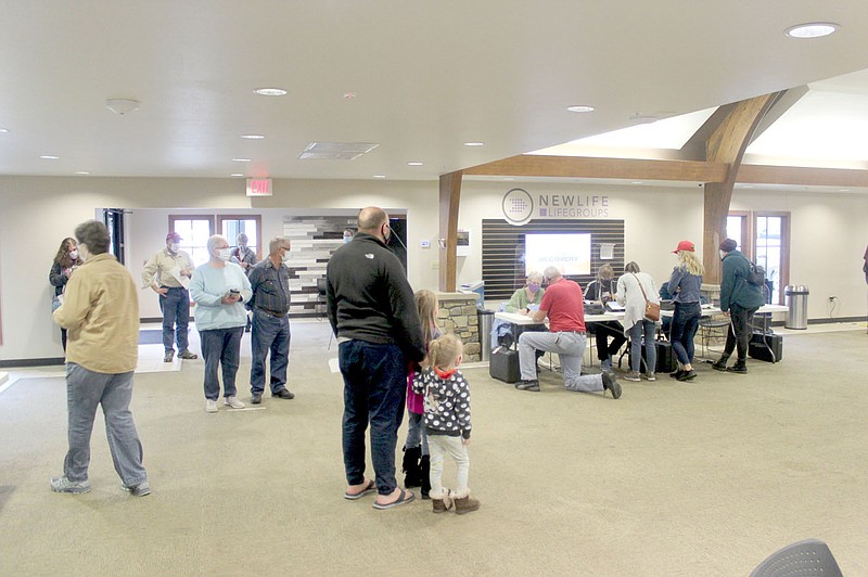 Keith Bryant/The Weekly Vista
Voters line up at the New Life Christian Church for early voting while volunteers get them checked in and ready to cast their ballots.