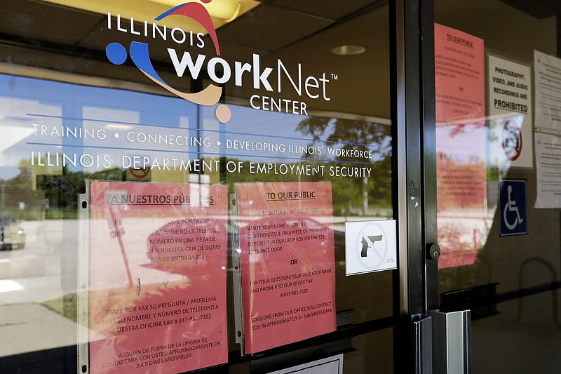 FILE - In this June 11, 2020, file photo, information signs are displayed at the closed Illinois Department of Employment Security WorkNet center in Arlington Heights, Ill. U.S. employers advertised for slightly fewer jobs in August while their hiring ticked up modestly. The Labor Department said Tuesday, Oct. 6, 2020, that the number of U.S. job postings on the last day of August dipped to 6.49 million, down from 6.70 million July. (AP Photo/Nam Y. Huh, File)