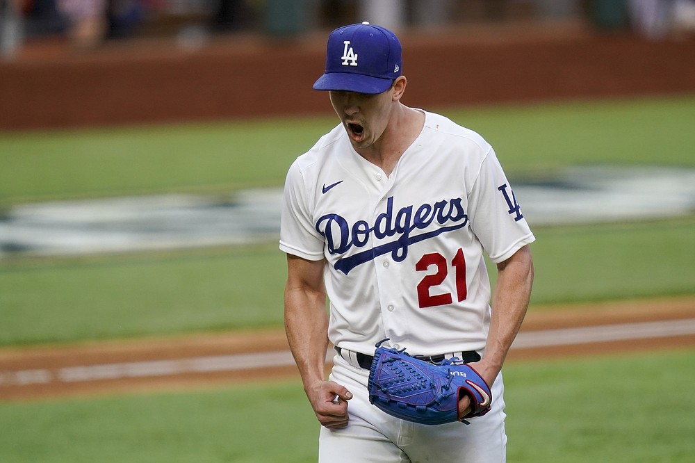 Los Angeles Dodgers starting pitcher Walker Buehler celebrates after striking out Atlanta Braves' Austin Riley during the sixth inning in Game 6 of a baseball National League Championship Series Saturday, Oct. 17, 2020, in Arlington, Texas. (AP Photo/Eric Gay)