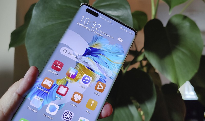 The new Huawei Mate 40 Pro smartphone is held for a photo, in London, Wednesday Oct. 21, 2020. Huawei, has unveiled its Mate 40 line of phones, Thursday Oct. 22, 2020, a product release that comes at a crucial moment for the company. (AP Photo/James Brooks)