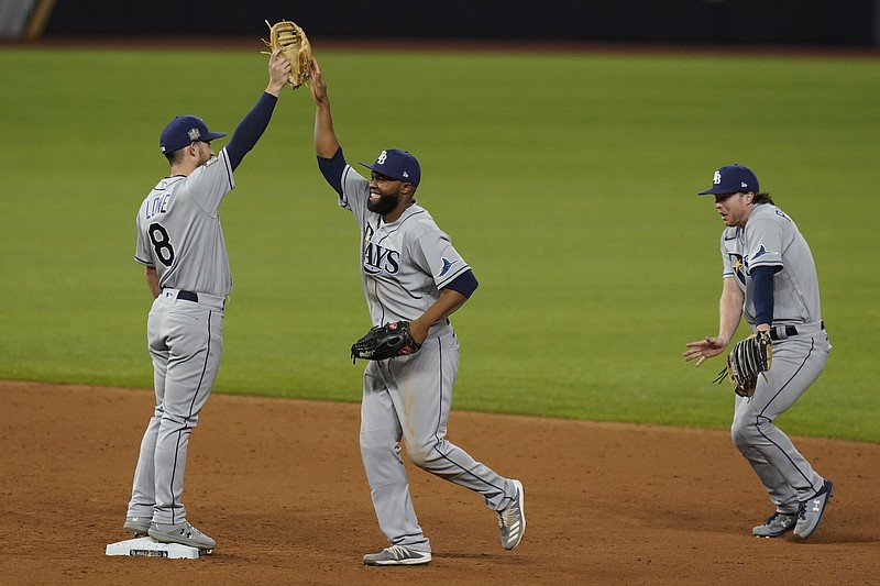 The Tampa Bay Rays celebrates their win against the Los Angeles Dodgers in Game 2 of the baseball World Series Wednesday, Oct. 21, 2020, in Arlington, Texas. Ray beat the Dodgers 6-4.(AP Photo/Eric Gay)