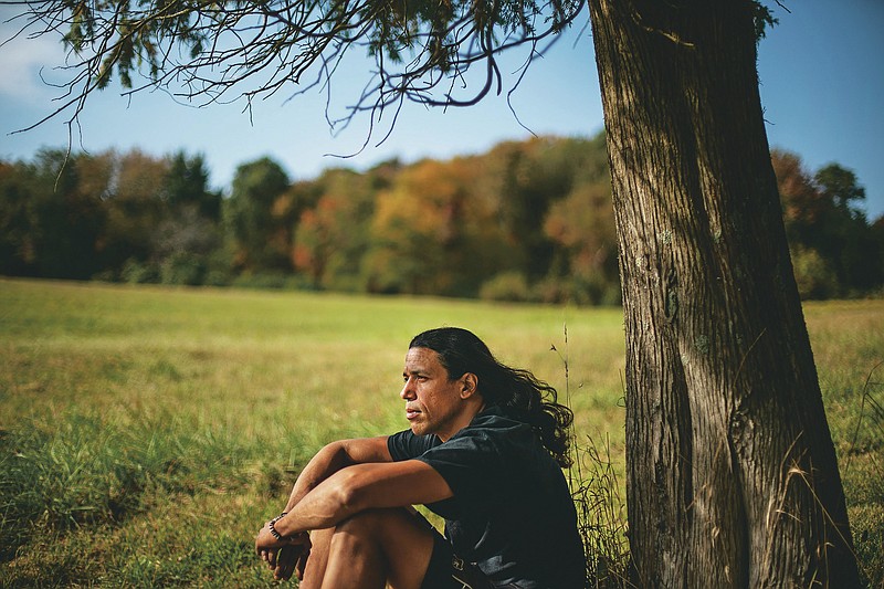 Annawon Weeden, 46, a member of the Mashpee Wampanoag Tribe, sits for a portrait outside his home in Oakdale, Conn., Friday, Sept. 25, 2020. "How do you pay somebody for that?" said Weeden when asked if governments should make financial reparations to Native people. "The most valuable thing anyone can have or possess ever is time and you don't get that time back. I don't get my ancestors back. It's degrading to think that you could buy your way out of what you put us in. Actions speak for themselves," Weeden said. "You don't got to pay me a dime. Clean up your community, show some respect. Pay the land the respect. It's never about me. It's about this land. I'm only here for a short time. This land had to last a lot longer. Your children are going to have to inherit this. What do you want to leave them? Let's look about our children and how our children's lives are going to turn out because if we can't get things to go better for them, we've all failed." (AP Photo/David Goldman)