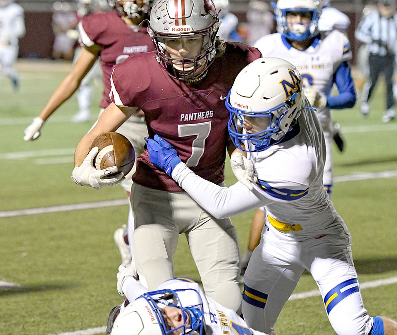 Bud Sullins/Special to Siloam Sunday
Siloam Springs senior Elijah Coffey runs after a catch as Mountain Home defenders try to bring him down.