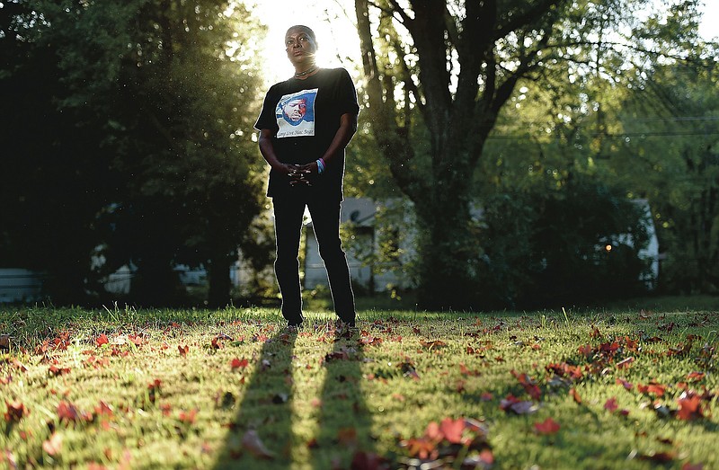 Rhonda Herring poses for a photo wearing a shirt with a picture of her slain son Brandon Herring,  in Raytown, Mo., on Thursday, Oct. 15, 2020. Herring's son was killed in Kansas City in 2017, and found in a creek bed. Herring says she knows who killed him and has experienced threatening behavior by them, including men shooting by her home. She is very dissatisfied with the way police have handled the case. (Jill Toyoshiba/The Kansas City Star via AP)