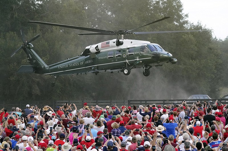 President Donald Trump arrives in the Marine One helicopter at a campaign rally as supporters cheer Friday, Oct. 23, 2020, in The Villages, Fla. (AP Photo/John Raoux)