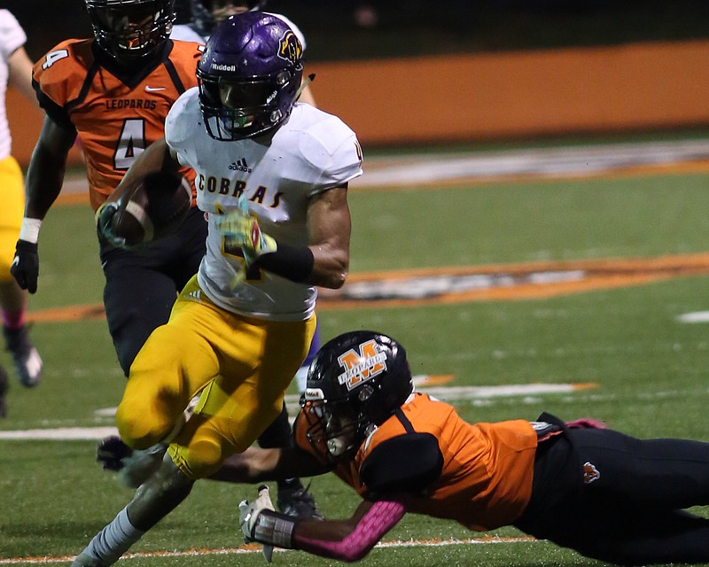 Fountain Lake junior Steven DeArmon (4) avoids a tackle while being chased by Malvern's Malique Reliford (4) in Friday night's 18-14 win over the Leopards. DeArmon finished with 25 carries for 179 yards and two touchdowns. - Photo by Corbet Deary of The Sentinel-Record