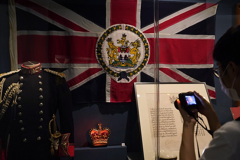 The standard and uniform of the former British Governors of Hong Kong, are displayed at the exhibition "The Hong Kong Story" in the Hong Kong Museum of History, Friday, Oct. 16, 2020. The exhibition "The Hong Kong Story" will be temporarily closed from 19 Oct 2020 for an extensive revamp. (AP Photo/Kin Cheung)
