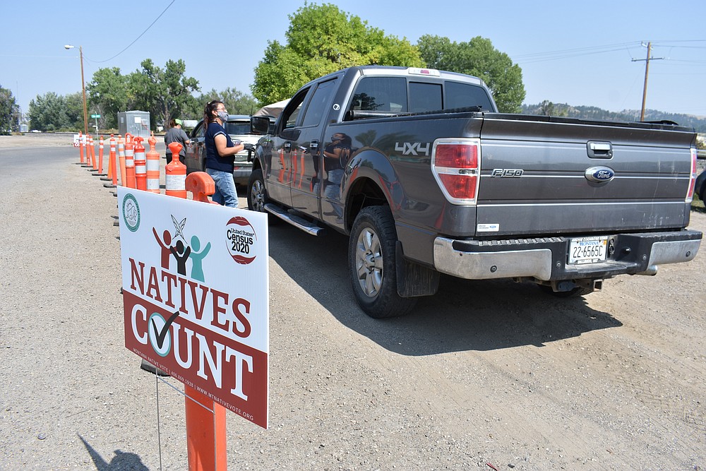 Vehicles stop at a drive-thru U.S. Census participation campaign organized by Montana Native Vote on the Crow Indian Reservation in Lodge Grass, Mont. on Wednesday, Aug. 26, 2020. There have always been geographic and cultural challenges to Census taking on Native lands, but the pandemic dealt a devastating setback. (AP Photo/Matthew Brown)
