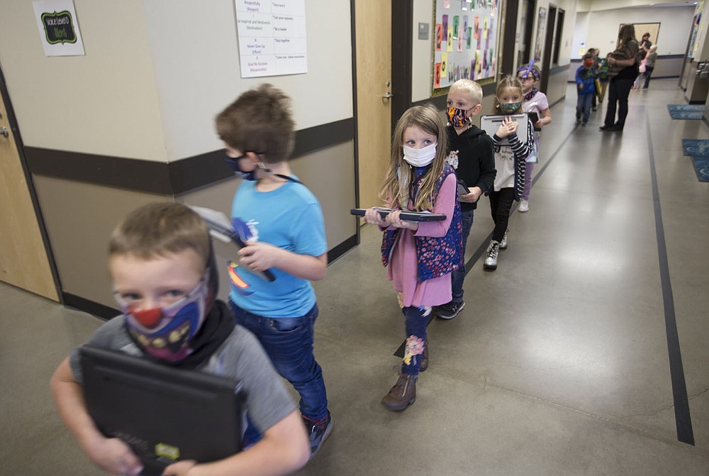 Students cross a hallway, Monday, October 5, 2020 at Clinton Elementary School in Clinton. Check out nwaonline.com/2010010Daily/ for today's photo gallery. (NWA Democrat-Gazette/Charlie Kaijo)