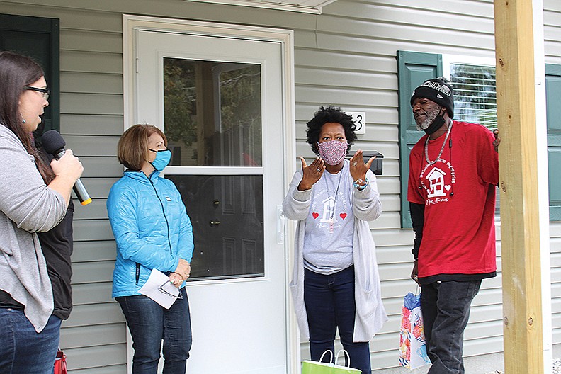 APOSTLES BUILD: Kitsonia Hancock, through interpreter Melinda Ables, left, thanks Garland County Habitat for Humanity for her new home on Saturday as her husband, Carvant, and Habitat Executive Director Cindy Wagstaff look on. - Photo by Tanner Newton of The Sentinel-Record