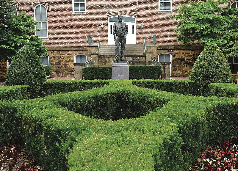 A statue of J. William Fulbright stands Wednesday, July 1, 2020. near the west entrance of Old Main on the University of Arkansas campus in Fayetteville. The statue was dedicated in 2002. Visit nwaonline.com/200702Daily/ for today's photo gallery.
(NWA Democrat-Gazette/Andy Shupe)