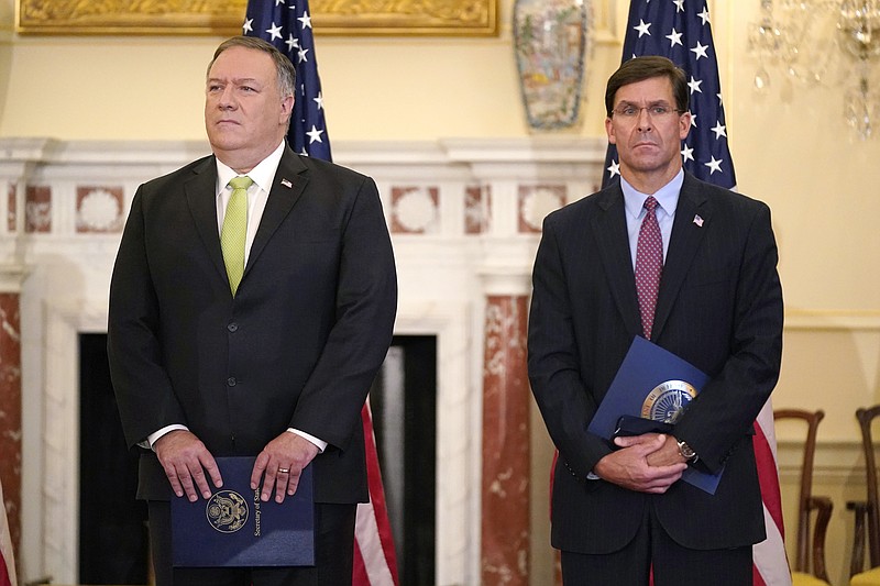 FILE - In this Sept. 21, 2020, file photo Secretary of State Mike Pompeo, left, and Defense Secretary Mark Esper attend a news conference at the U.S. State Department in Washington. Just a week before November's election, Pompeo and Esper will visit India for meetings focused largely on countering China's growing global influence. (AP Photo/Patrick Semansky, File)