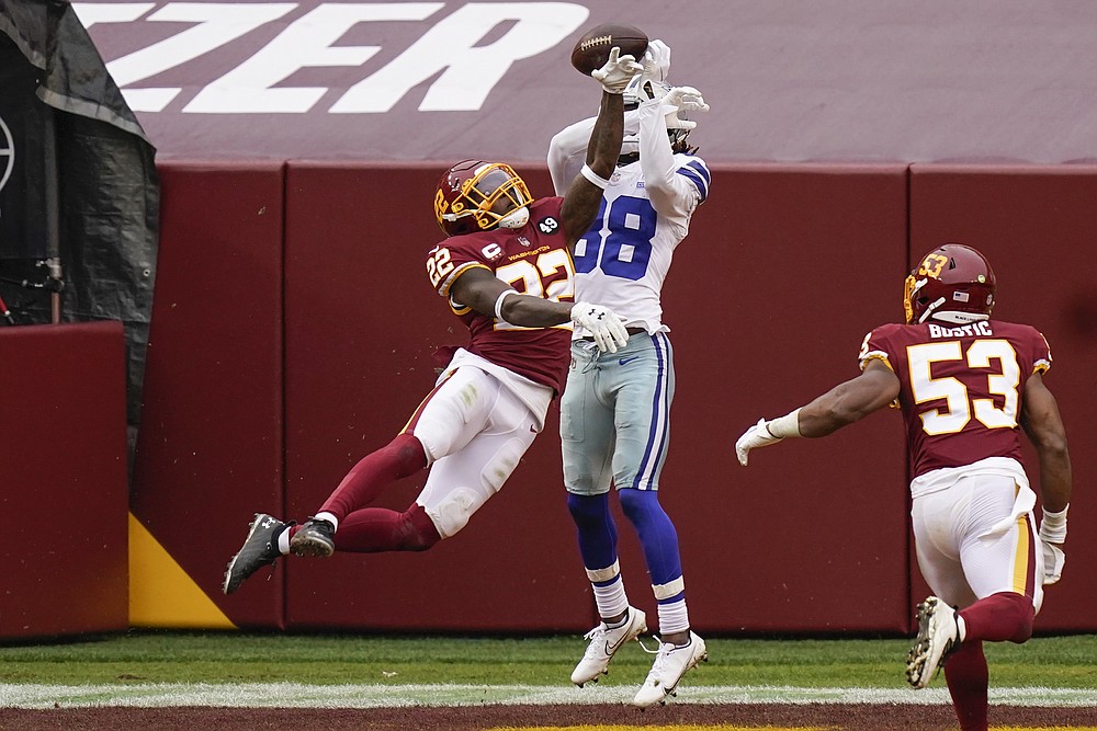 Landover, United States. 25th Oct, 2020. Dallas Cowboys quarterback Andy  Dalton (14) evades Washington Football Team linebacker Cole Holcomb (55)  during the first half of an NFL football game at FedEx Field