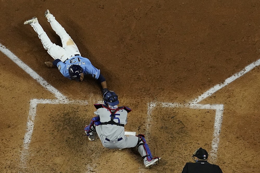 Tampa Bay Rays' Manuel Margot is tagged out at home by Los Angeles Dodgers catcher Austin Barnes trying to steal during the fourth inning in Game 5 of the baseball World Series Sunday, Oct. 25, 2020, in Arlington, Texas. (AP Photo/David J. Phillip)