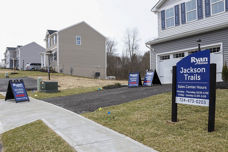Model homes and for sale signs line the streets as construction continues at a housing plan in Zelienople, Pa., Wednesday, March 18, 2020. Sales of new homes fell by 3.5% in September to a seasonally-adjusted annual rate of 959,000 million units. The Commerce Department said Monday, Oct. 26, 2020, that despite the modest decrease, sales of new homes are up 32.1% from a year earlier, as the housing market remains strong despite the pandemic. (AP Photo/Keith Srakocic)