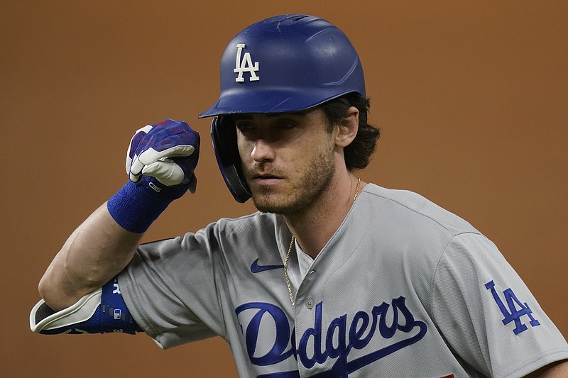 Los Angeles Dodgers' Cody Bellinger celebrates his RBI-single against the Tampa Bay Rays during the first inning in Game 5 of the baseball World Series Sunday, Oct. 25, 2020, in Arlington, Texas. (AP Photo/Eric Gay)