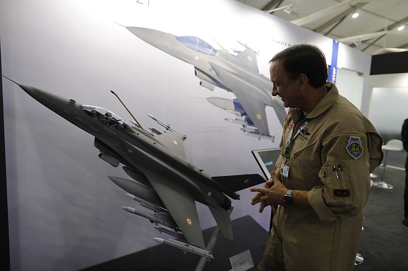 FILE - In this Feb. 5, 2020, file photo, Lockheed Martin's Robert Balserak, Lead Executive, Air Superiority Programs, explains the capabilities of the F-21 at the DefExpo in Lucknow, India. China's government said Monday, Oct. 26, 2020, it will impose sanctions on U.S. military contractors including Boeing Co.'s defense unit and Lockheed Martin Corp. for supplying weapons to rival Taiwan, stepping up a feud with Washington over security and Beijing's strategic ambitions. (AP Photo/Rajesh Kumar Singh, File) story.lead_photo.caption