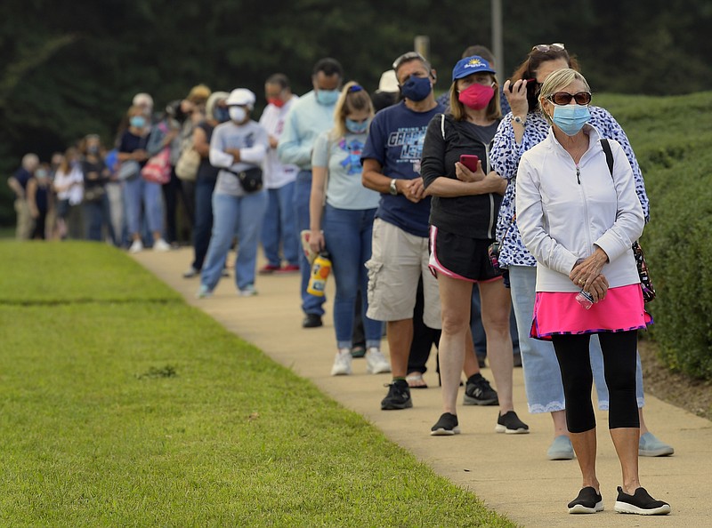 Voters in Virginia wait in a long line to cast their ballots at the Fairfax County Government Center for the November presidential election on first day of early voting in that state on Sept. 18. MUST CREDIT: Washington Post photo by John McDonnell.