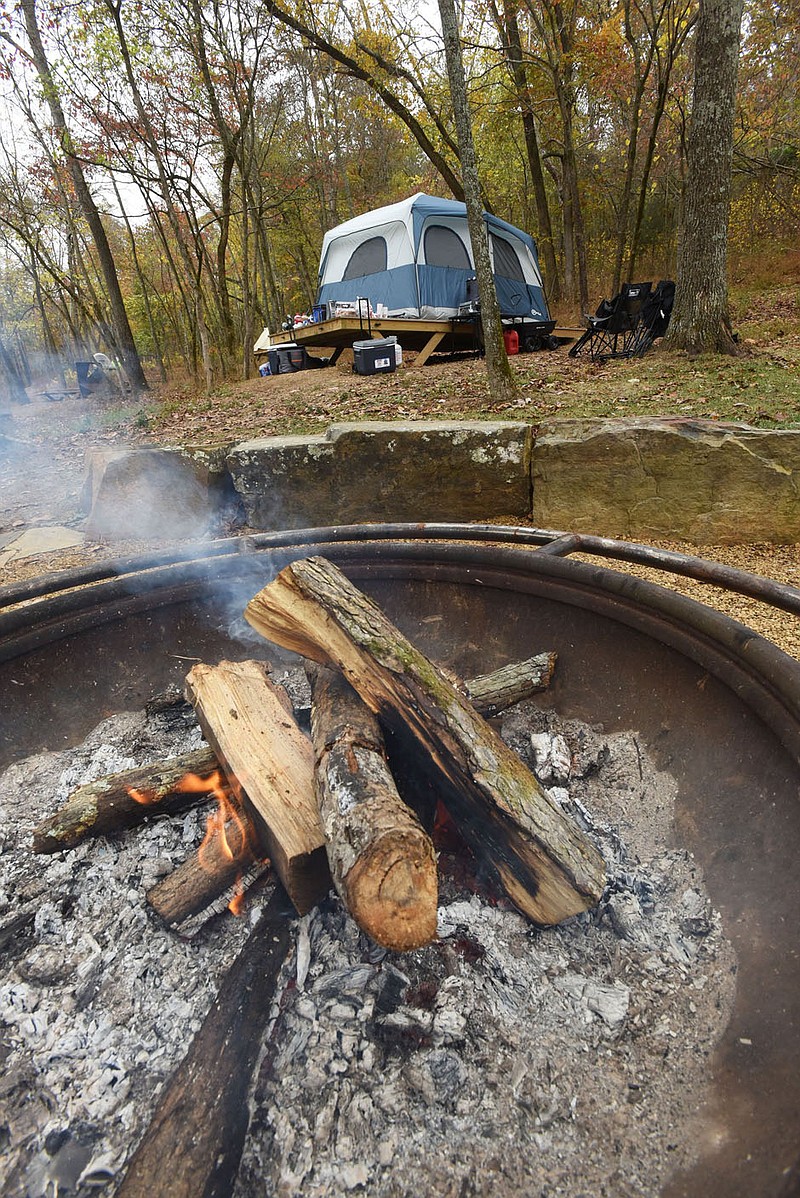 COLER WELCOMES CAMPERS
Flames flicker in the community fire ring in the campground at Coler Mountain Bike Preserve in Bentonville. New campsites at the preserve opened for camping this weekend, with most occupied on Saturday. Sites range from small and large tent platforms to sites for camper vans. Fees are $15 per night for small tent platforms, $25 for a large platform and $30 for camper van sites. Advance reservations are required and accepted online at www.peelcompton.org. The mountain bike preserve is in northwest Bentonville and features miles of mountain bike trails, a hard-surface trail and the campground. There is no cost to ride the trails. Go to nwaonline.com/201025Daily/ to see more photos.
(NWA Democrat-Gazette/Flip Putthoff)