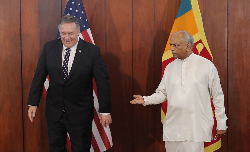 Sri Lankan Foreign Minister Dinesh Gunawardena gestures towards U.S. Secretary of State Mike Pompeo before their meeting in Colombo, Sri Lanka, Wednesday, Oct. 28, 2020. Pompeo plans to press Sri Lanka to push back against Chinese assertiveness, which U.S. officials complain is highlighted by predatory lending and development projects that benefit China more than the presumed recipients. The Chinese Embassy in Sri Lanka denounced Pompeo’s visit to the island even before he arrived there, denouncing a senior U.S. official’s warning that the country should be wary of Chinese investment. (AP Photo/Eranga Jayawardena, Pool)